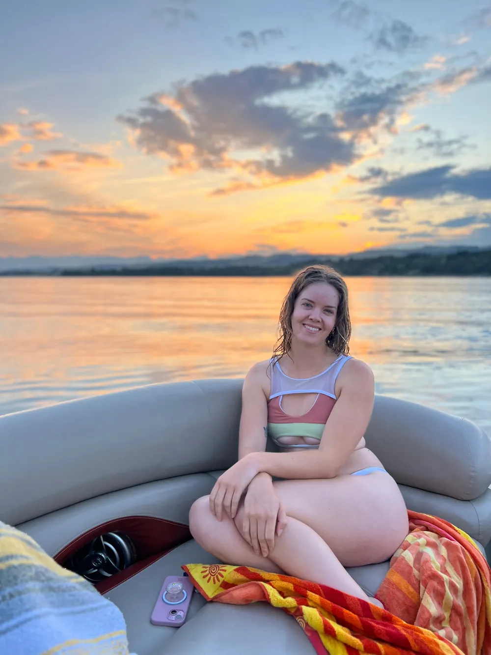 A guest seated at the stern as the sun goes down